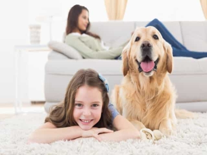 Girl laying with a dog on the floor