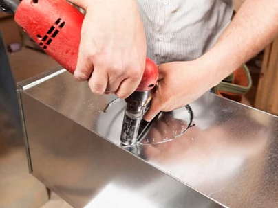 Man cutting through metal