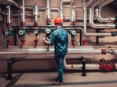 Technician checking plumbing pressure