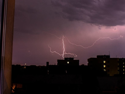 lightning in the sky over buildings
