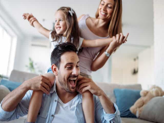 Family playing with daughter