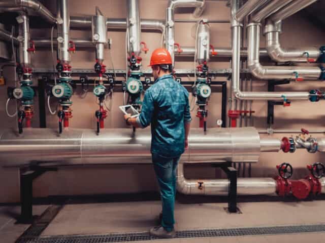 Technician checking plumbing pressure